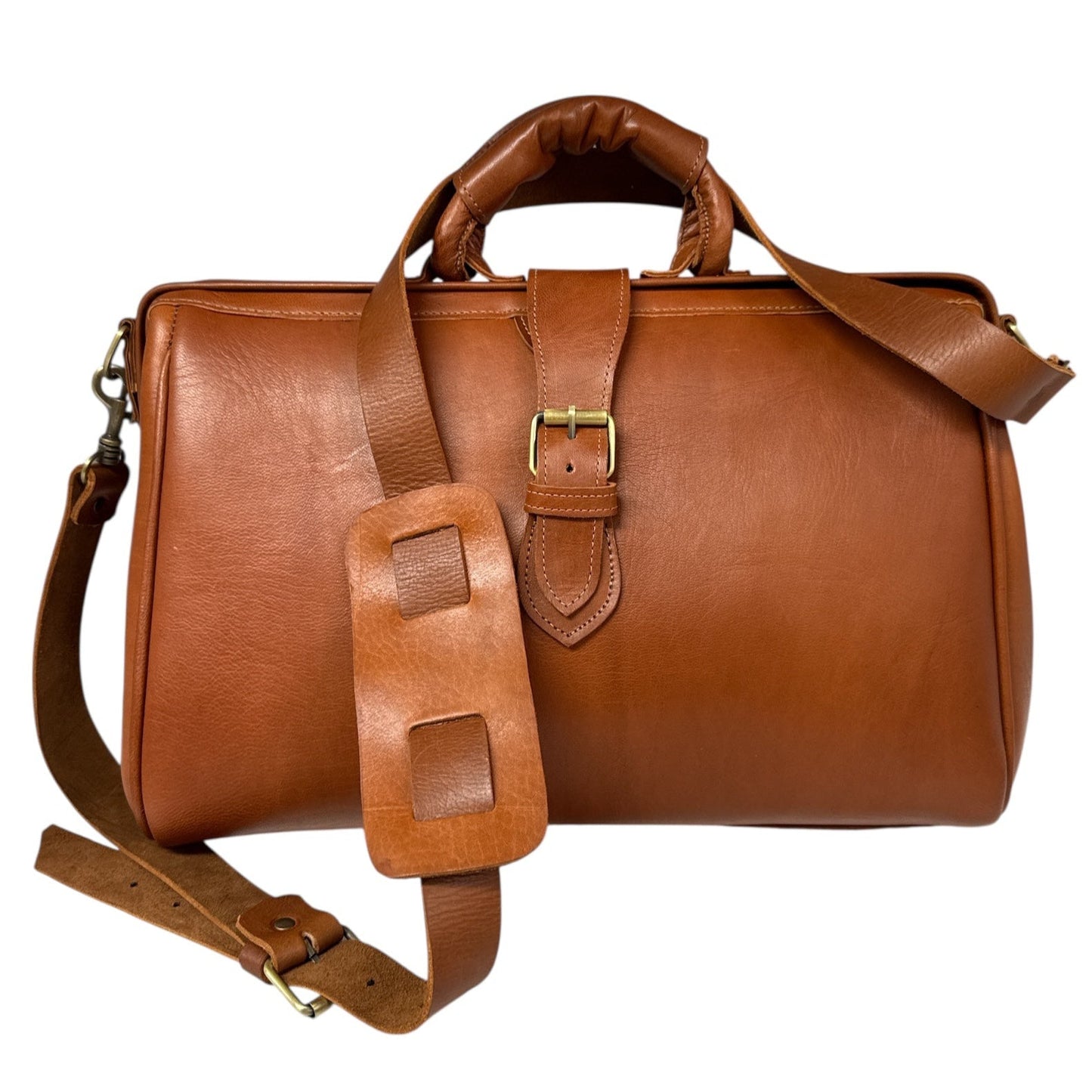 Brown leather bag with a strap on a white background