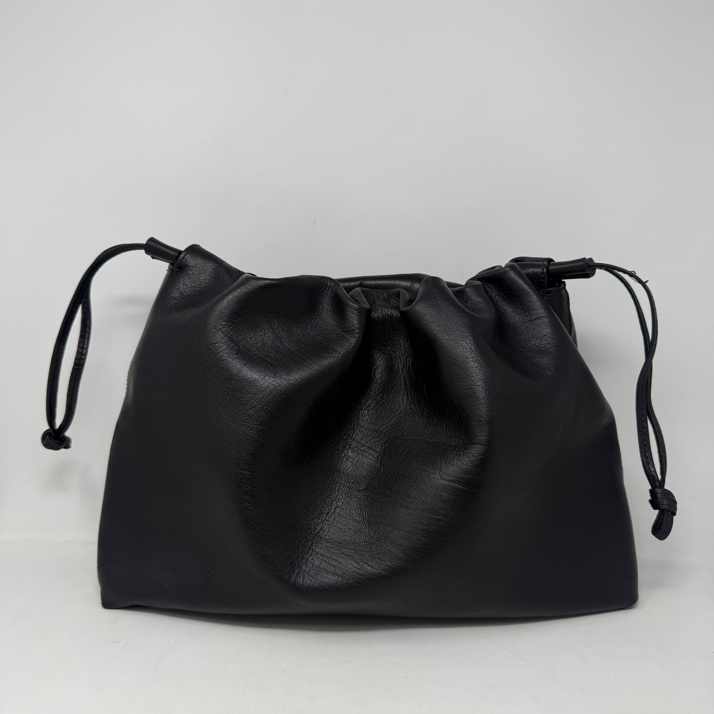 Black drawstring pouch on a light gray background