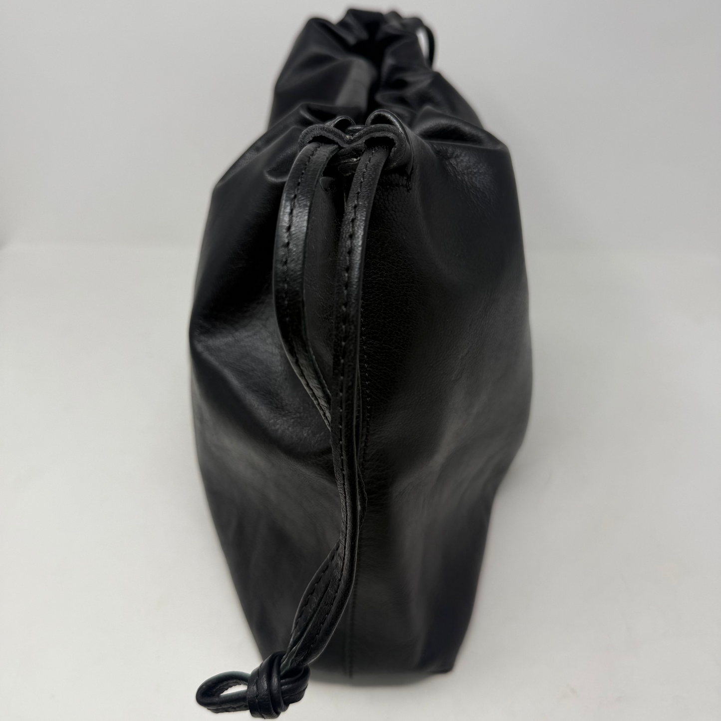 Black drawstring pouch on a white background