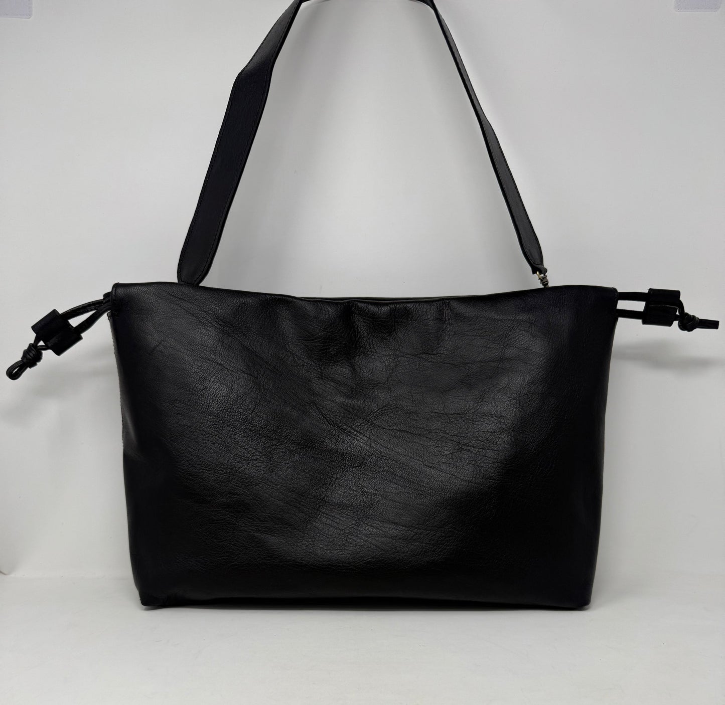 Black leather handbag on a white background