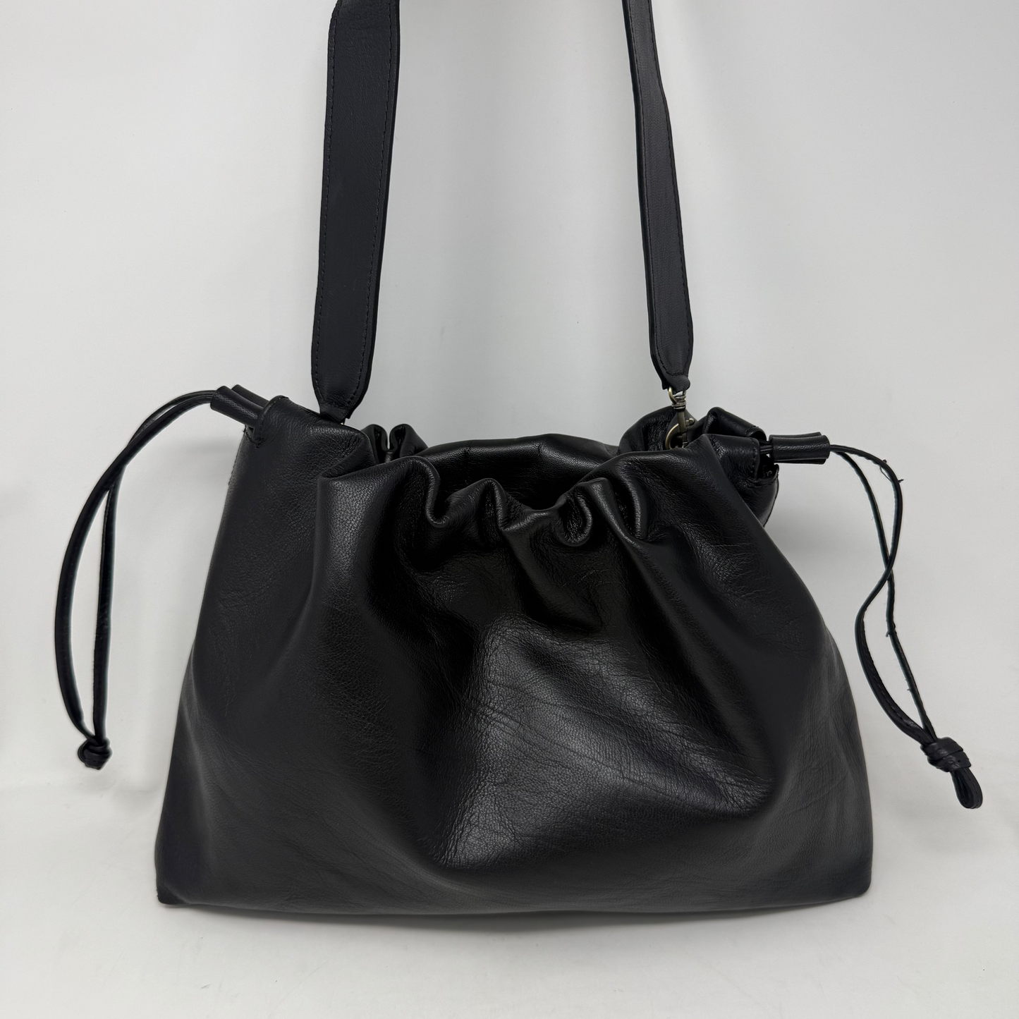 Black leather drawstring bag on a white background