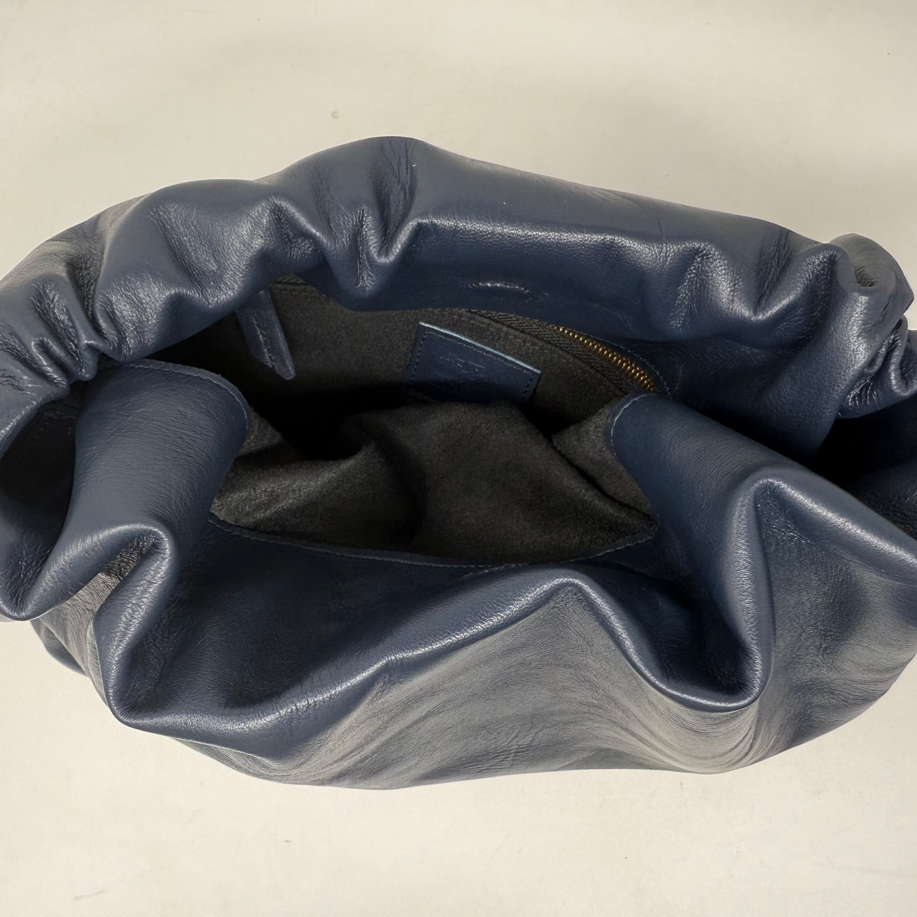 Blue leather bag on a beige background