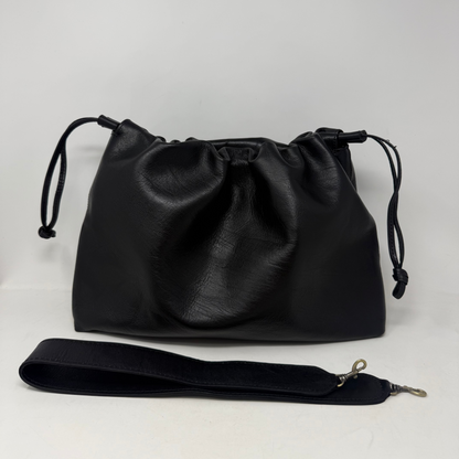 Black leather drawstring bag with a strap on a white background