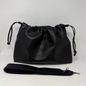 Black leather drawstring bag with a strap on a white background