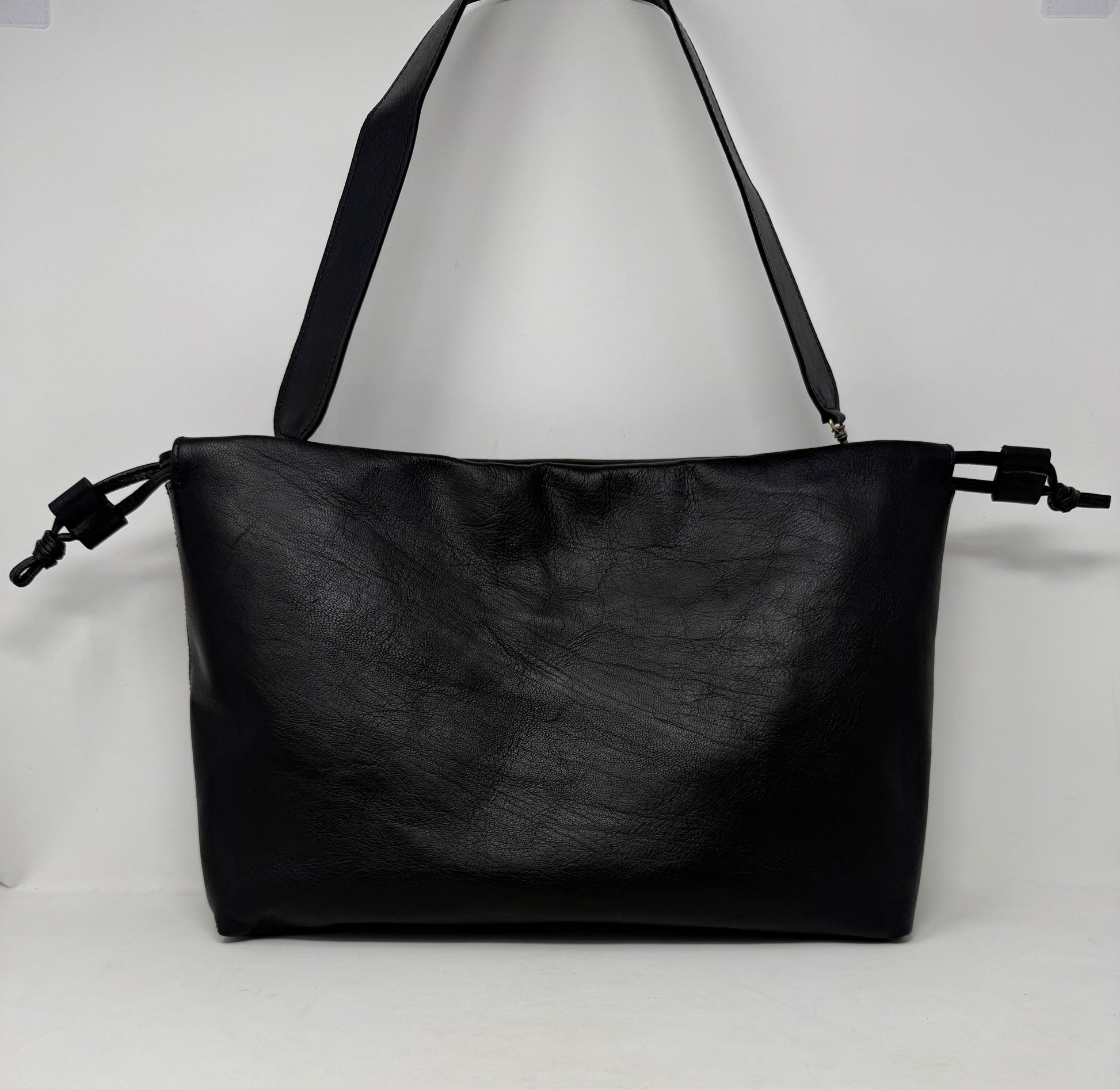Black leather handbag on a white background