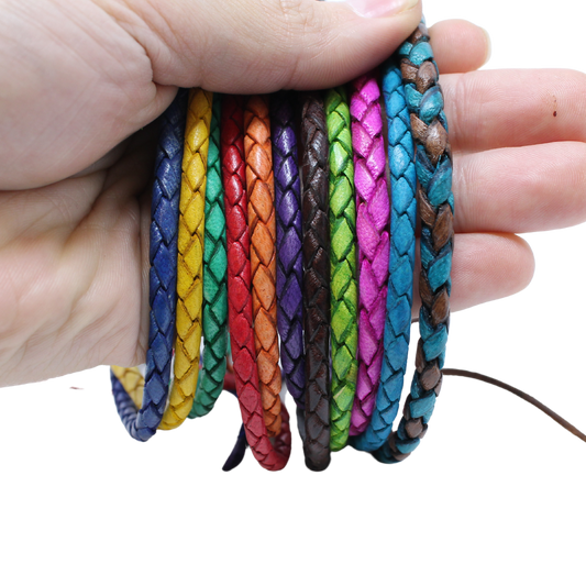 Adjustable twisted artisan leather bracelet jewelry for men and women in multiple vibrant colors held in hand