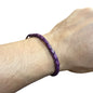 Adjustable twisted artisan leather bracelet jewelry for men and women in purple on wrist