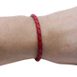 Adjustable twisted artisan leather bracelet jewelry for men and women in red on wrist by Artisan Stories