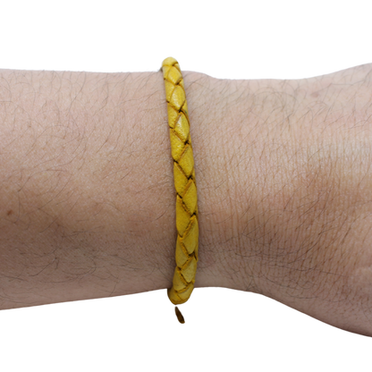 Adjustable twisted artisan leather bracelet jewelry for men and women in yellow on wrist by Artisan stories