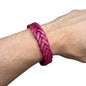 handmade braided leather bracelet in vibrant pink worn on wrist
