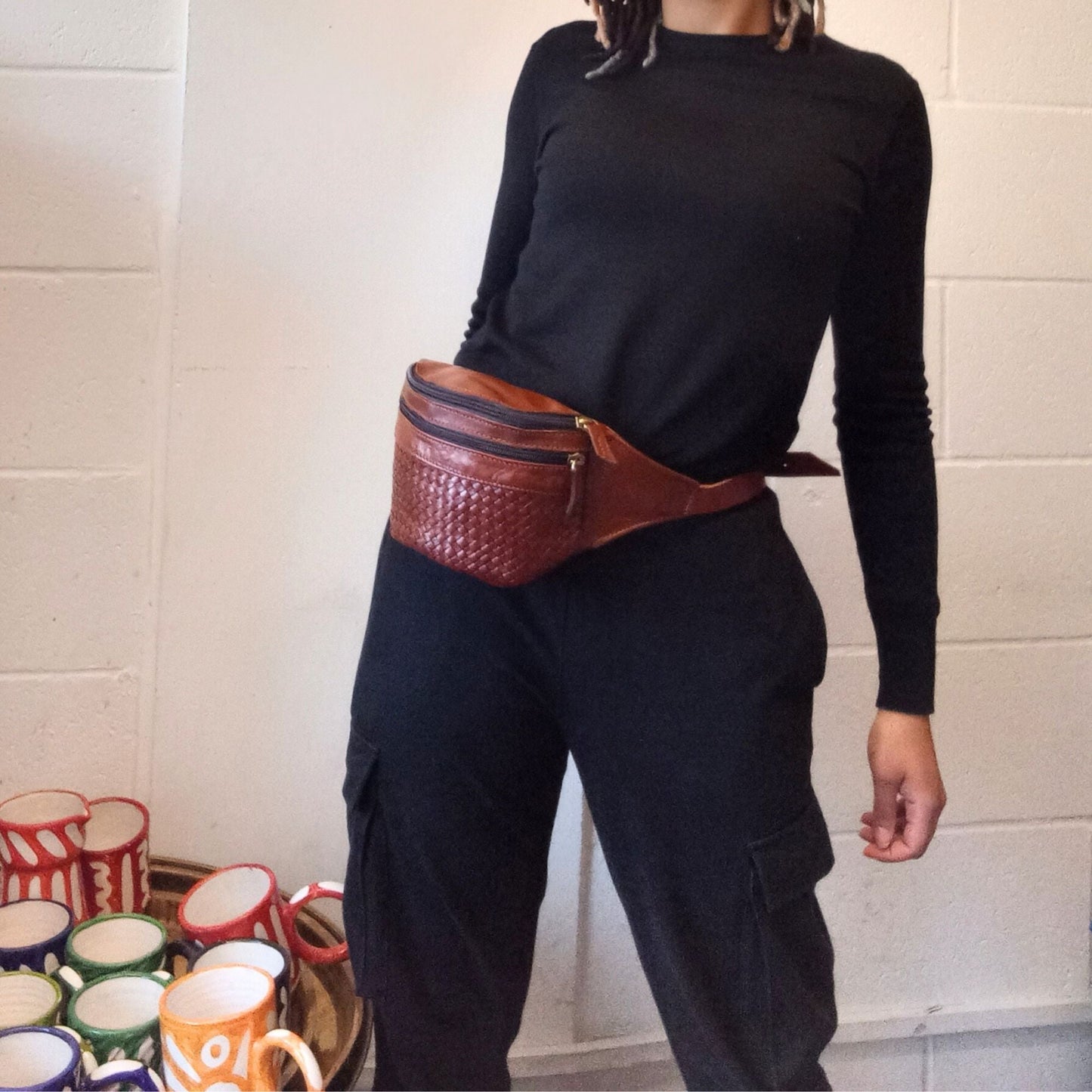 model with a leather bum bag in tan brown